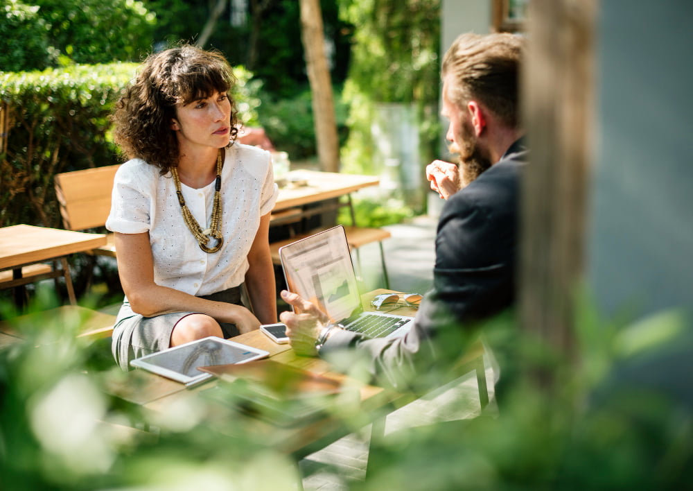 two people meeting at a cafe with papers